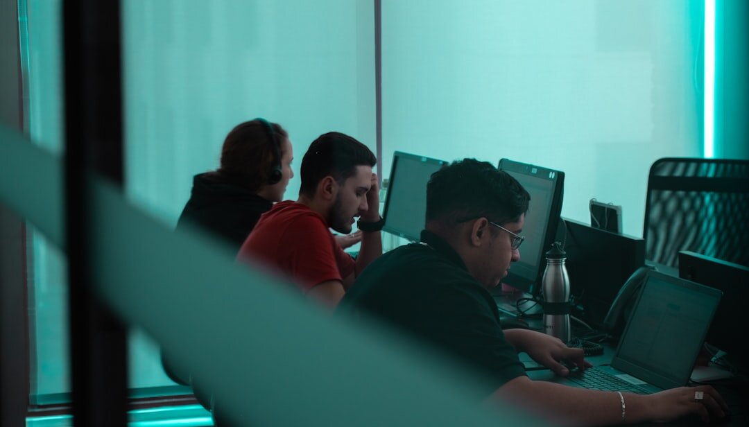 Editorial team in a modern newsroom working together at computers